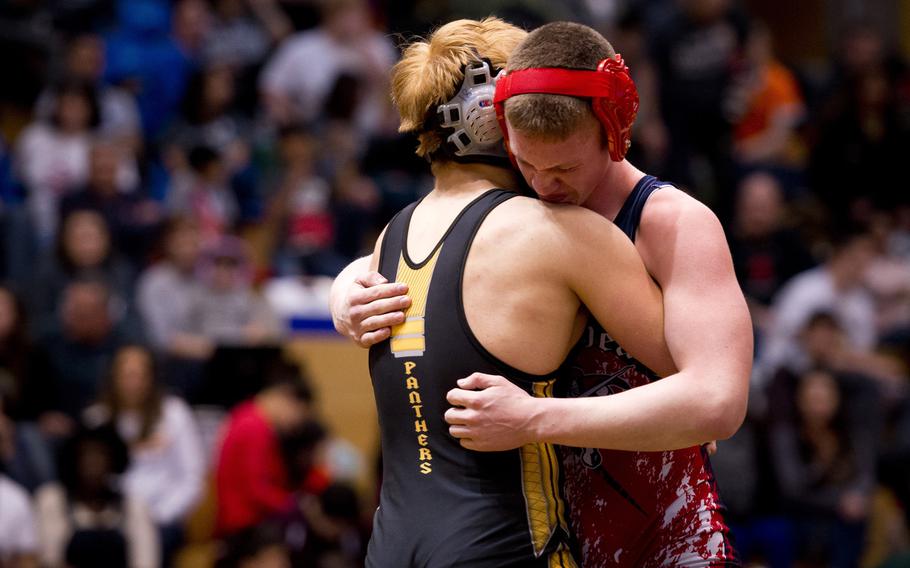 Stuttgart's Kevin Wentland, left, embraces Lakenheath's Joseph Krussick during the DODDS-Europe wrestling championship at Clay Kaserne, Germany, on Saturday, Feb. 20, 2016. Wentland pinned Krussick at two minutes, 46 seconds.
