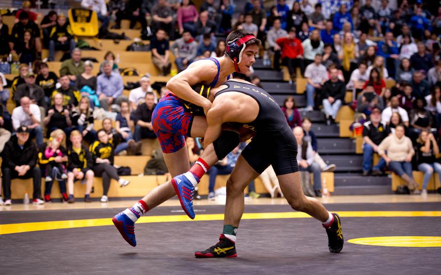 Vicenza's Josh Badillo shoots at Ramstein's Stanley Cruz during the DODDS-Europe wrestling championship at Clay Kaserne, Germany, on Saturday, Feb. 20, 2016. Cruz won 126-pound weight class with a 1-0 decision over Badillo.