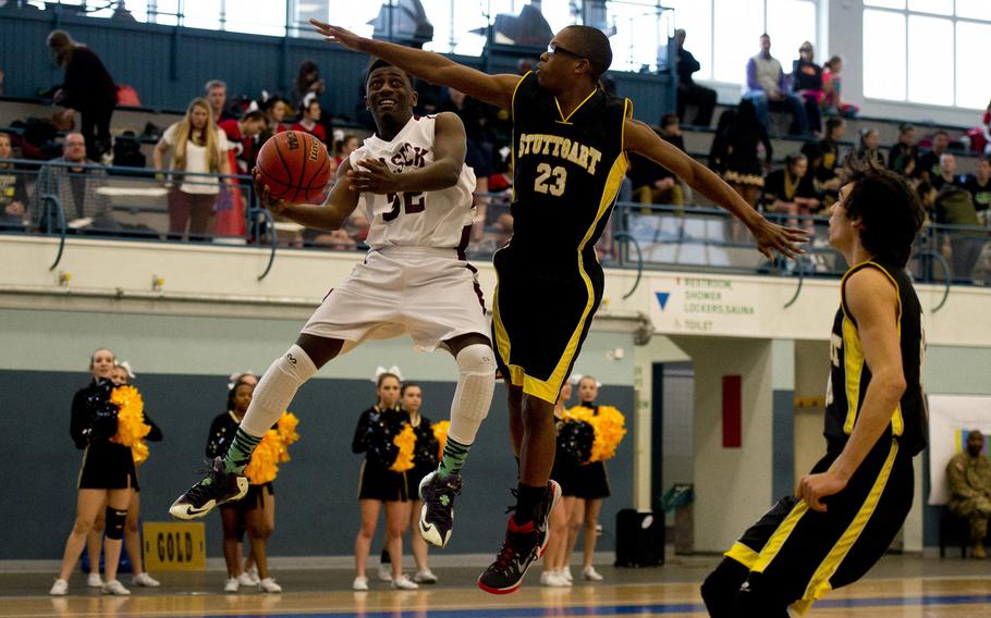 Vilseck's Matthew Horton tries to get a shot past Stuttgart's Jordan Thigpen during opening day of the DODDS-Europe basketball championships at Vogelweh, Germany, Wednesday, Feb. 24, 2016. Stuttgart won the Division I game 59-44.