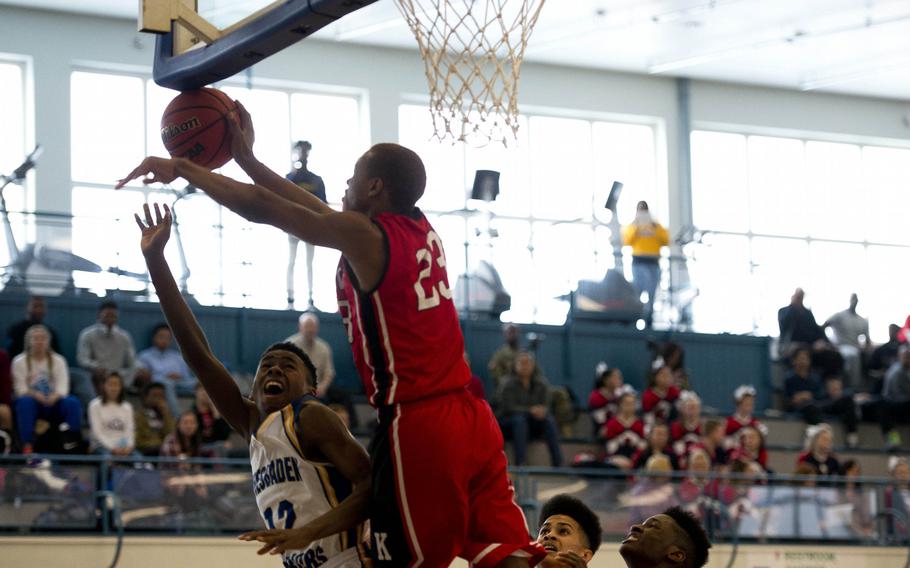 Kaiserslautern's Ja'Markus Myles blocks Wiesbaden's David Williams during opening day of the DODDS-Europe basketball championships at Vogelweh, Germany, Wednesday, Feb. 24, 2016. Kaiserslautern won the Division I game 46-38.