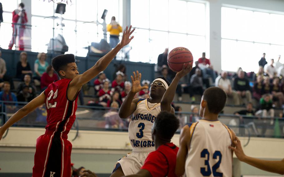 Wiesbaden's Caleb Brown attempts a shot past Kaiserslautern's Markell Johnson during opening day of the DODDS-Europe basketball championships at Vogelweh, Germany, Wednesday, Feb. 24, 2016. Kaiserslautern won the Division I game 46-38.