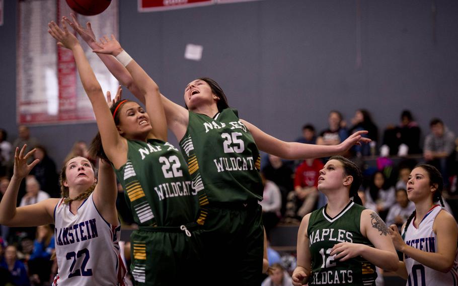 Naples' Angelica Sheils, center, reaches for a rebound over fellow teammate Jilian Thurston and Ramstein's Lindsey Breton during opening day of the DODDS-Europe basketball championships at Vogelweh, Germany, Wednesday, Feb. 24, 2016. Ramstein won the Division I game 52-13.