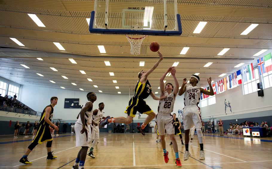 Stuttgart's Noah Layton gets a rebound over Vilseck's Timothy Simmons during a Division I game on opening day of the DODDS-Europe basketball championships at Vogelweh, Germany, Wednesday, Feb. 24, 2016. Stuttgart won 59-44.