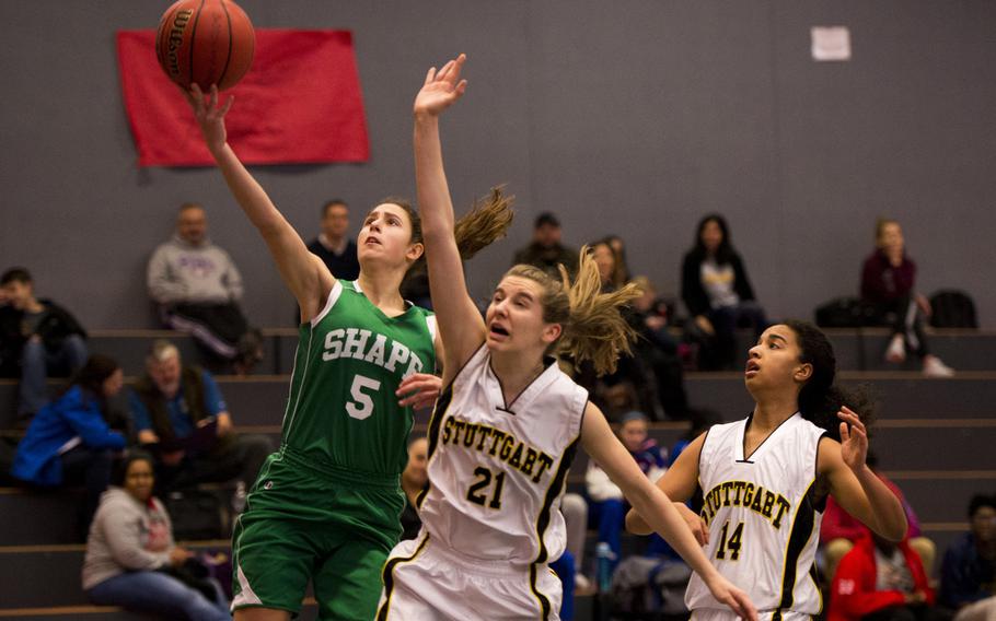 SHAPE's Begonia Rodriguez gets past Stuttgart's Autumn Kearny during a Division I game on opening day of the DODDS-Europe basketball championships at Vogelweh, Germany, Wednesday, Feb. 24, 2016. Stuttgart won 42-14.