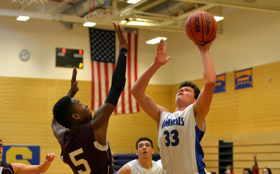 Rota's Zach Heisler shoots over  AFNORTH defender Malik Mays  in opening-day Division II action at the DODDS-Europe basketball championships in Wiesbaden, Germany, Wednesday, Feb. 24, 2016.Rota beat the Lions 61-26.