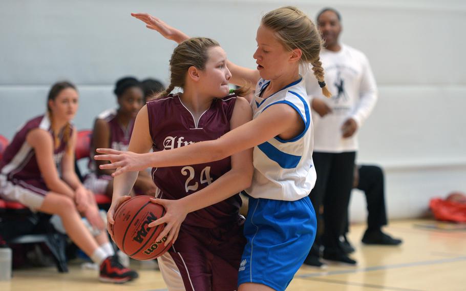 AFNORTH's Josie Bosch looks to pass while pressured by Marymount's Ama Mathiesen  in opening-day Division II action at the DODDS-Europe basketball championships in Wiesbaden, Germany, Wednesday, Feb. 24, 2016. AFNORTH won the game 17-5.