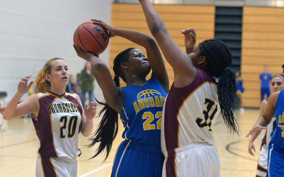 Ansbach's Sabiana Edouard tries to get a shot off against Baumholder's Eliyah Tilman in an opening-day Division III game at the DODDS-Europe basketball championships in Wiesbaden, Germany, Wednesday, Feb. 24, 2016. Ansbach won 27-21.