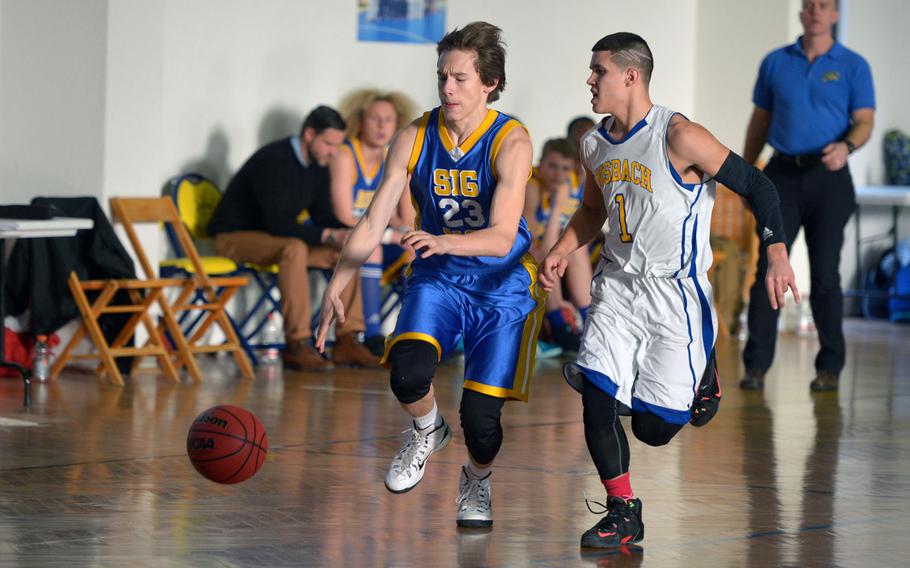 Sigonella's Aaron Jacobs drives the ball up the court against Ansbach's Yadiel Rodriguez in a Division III game at the DODDS-Europe basketball championships in Wackernheim, Germany, Wednesday, Feb. 24, 2016. Ansbach won the game 36-32.
