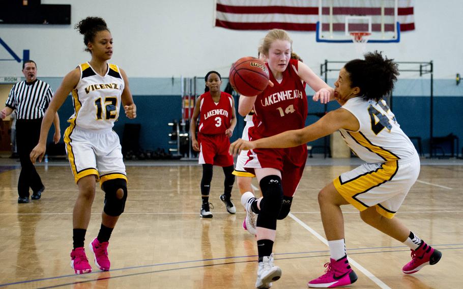 Lakenheath's Reese Estus drives the ball past Vicenza's Aerial Rouse on day two of the DODDS-Europe basketball championships at Vogelweh, Germany, Wednesday, Feb. 25, 2016. Vicenza won 45-28.