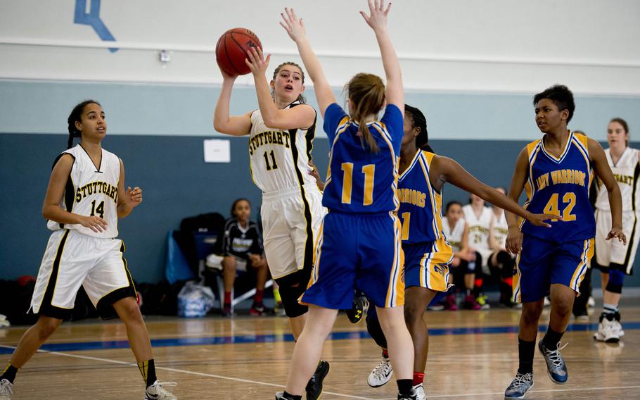 Stuttgart's Kat Farrar tries to pass over Wiesbaden's Belle Kelley on day two of the DODDS-Europe basketball championships at Vogelweh, Germany, Wednesday, Feb. 25, 2016. Stuttgart won the Division I game 47-7.