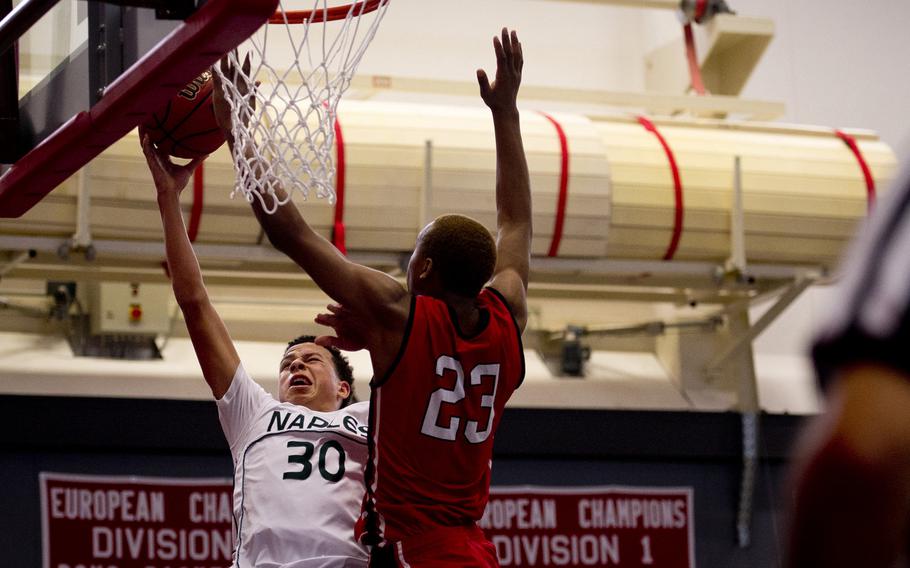 Naples' Karrington Evans gets a layup past Kaiserslautern's Ja'Markus Myles on day two of the DODDS-Europe basketball championships at Vogelweh, Germany, Wednesday, Feb. 25, 2016. Kaiserslautern won the Division I game 42-38.