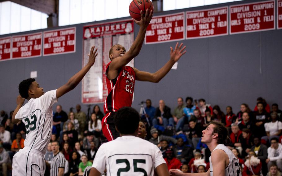 Kaiserslautern's Ja'Markus Myles goes for a layup over Naples defenders on day two of the DODDS-Europe basketball championships at Vogelweh, Germany, Wednesday, Feb. 25, 2016. Kaiserslautern won 42-38.