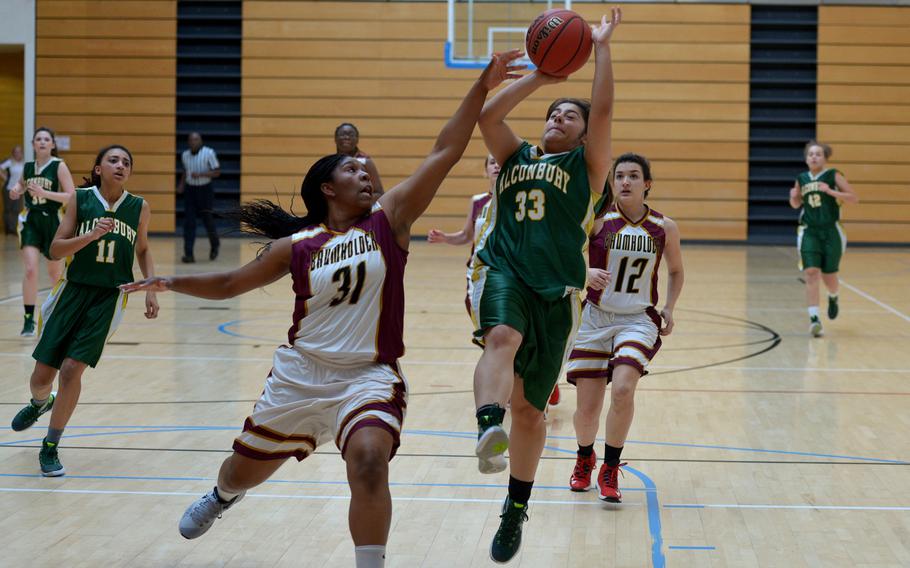 Alconbury's Roni Teti goes in for a shot against Baumholder's Eliyah Tillman in a Division III game at the DODDS-Europe basketball championships in Wiesbaden, Germany, Thursday, Feb. 25, 2016. The Dragons beat Baumholder 21-20.