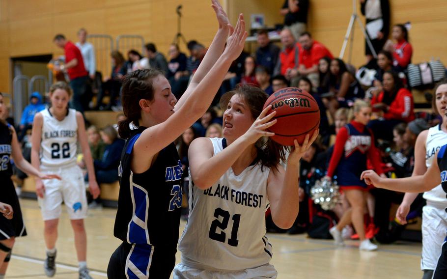 Black Forest Academy's Mia Rottier looks for a shot against the defense of Hohenfels' Mikaela McCarson  in a Division II game at the DODDS-Europe basketball championships in Wiesbaden, Germany, Thursday, Feb. 25, 2016.BFA won 22-5.