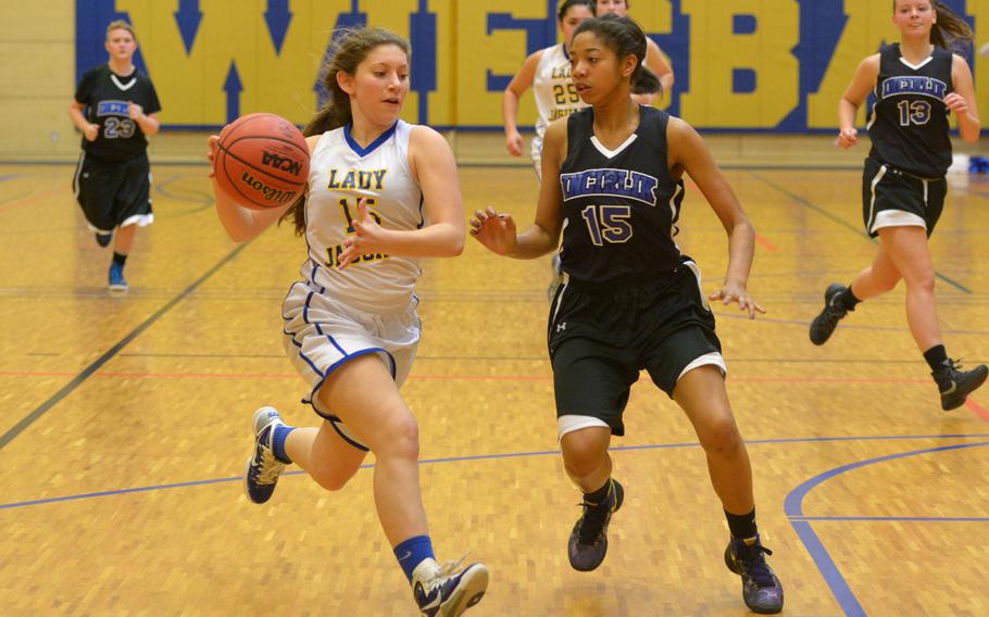 Sigonella's Jessica Jacobs drives against Incirlik's Ayana Pettigrew-Wilkes in a Division III game at the DODDS-Europe basketball championships in Wiesbaden, Germany, Friday, Feb. 26, 2016. Sigonella won the game 35-9.
