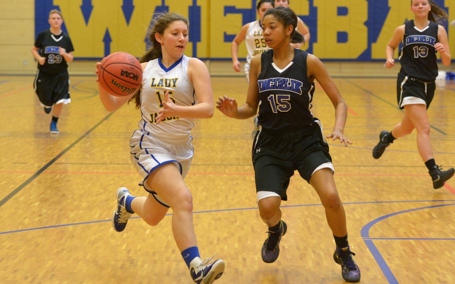 Sigonella's Jessica Jacobs drives against Incirlik's Ayana Pettigrew-Wilkes in a Division III game at the DODDS-Europe basketball championships in Wiesbaden, Germany, Friday, Feb. 26, 2016. Sigonella won the game 35-9.