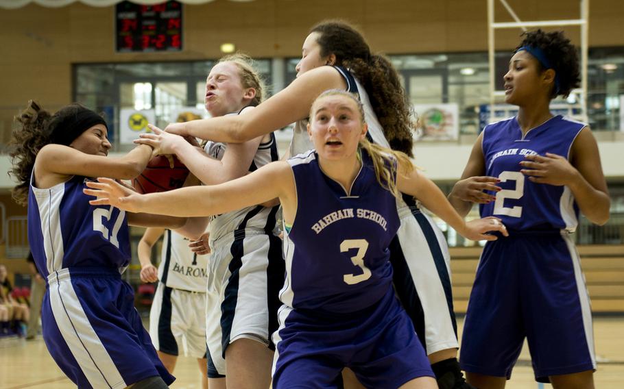 Bahrain School's Fatima Sakhri, left, battles Bitburg's Baileigh McFall for the ball during a DODDS-Europe Division II semifinal game at Clay Kaserne, Germany, Friday, Feb. 26, 2016. Bitburg won 42-16.