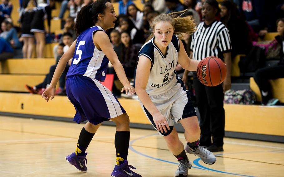 Bitburg's Alexa Landenberger dribbles around Bahrain's Melissa Atienza during a DODDS-Europe Division II semifinal game at Clay Kaserne, Germany, Friday, Feb. 26, 2016. Bitburg won the game 42-16. 