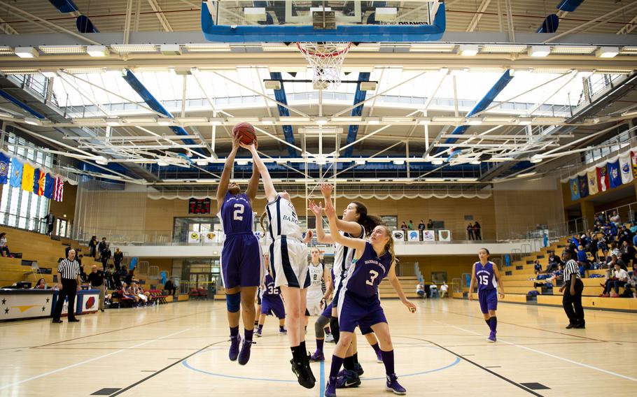 Bahrain's Summer Winston, left, gets a rebound over Bitburg's Baileigh McFall during a DODDS-Europe Division II semifinal game at Clay Kaserne, Germany, Friday, Feb. 26, 2016. Bitburg defeated Bahrain 42-16. 