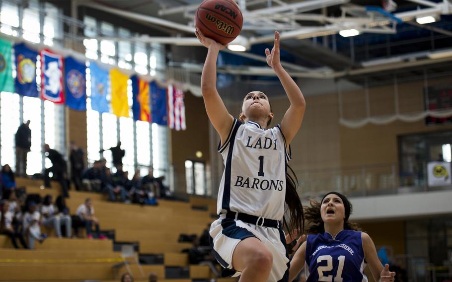 Bitburg's Hailey McKenna gets past Bahrain's Fatima Sakhri for a shot during a DODDS-Europe Division II semifinal game at Clay Kaserne, Germany, Friday, Feb. 26, 2016. Bitburg beat Bahrain 42-16. 