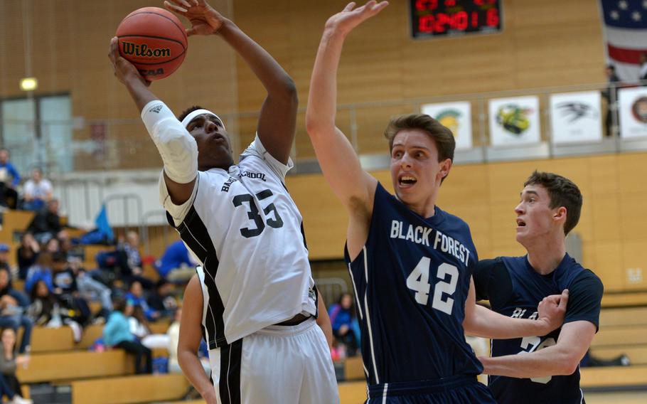 Bahrain's Noah Henderson shoots over Black Forest Academy's Johathan Lienart  in a Division II semifinal at the DODDS-Europe basketball championships in WIesbaden, Germany. Friday, Feb. 26, 2016. BFA defeated Bahrain 52-50 to advance to Saturday's final against Rota.
