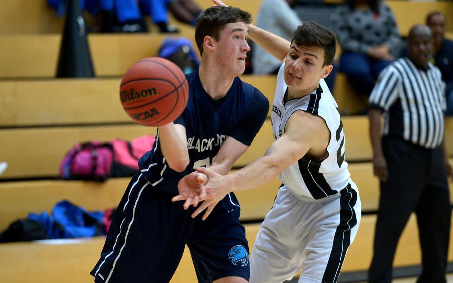 Black Forest Academy's Noah Greathouse make a no-look pass to a teammate as Bahrain's Tyler Betro defends in a Division II semifinal at the DODDS-Europe basketball championships in WIesbaden, Germany. Friday, Feb. 26, 2016. BFA defeated Bahrain 52-50 to advance to Saturday's final against Rota.