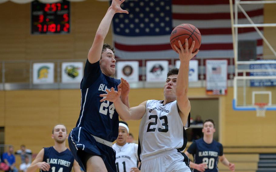 Black Forest Academy's Jonah Greathouse tries to stop Bahrain's Tyler Betro's drive to the basket in a Division II semifinal at the DODDS-Europe basketball championships in WIesbaden, Germany. Friday, Feb. 26, 2016. BFA defeated Bahrain 52-50 to advance to Saturday's final against Rota.