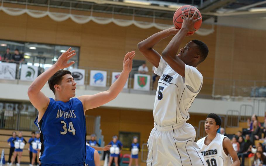Hohenfels' Keyshawn Hunter shoots over Rota's Andrew Drake  in a Division II semifinal at the DODDS-Europe basketball championships in WIesbaden, Germany. Friday, Feb. 26, 2016. Rota defeated Hohenfels 54-36 to advance to Saturday's final against Black Forest Academy.
