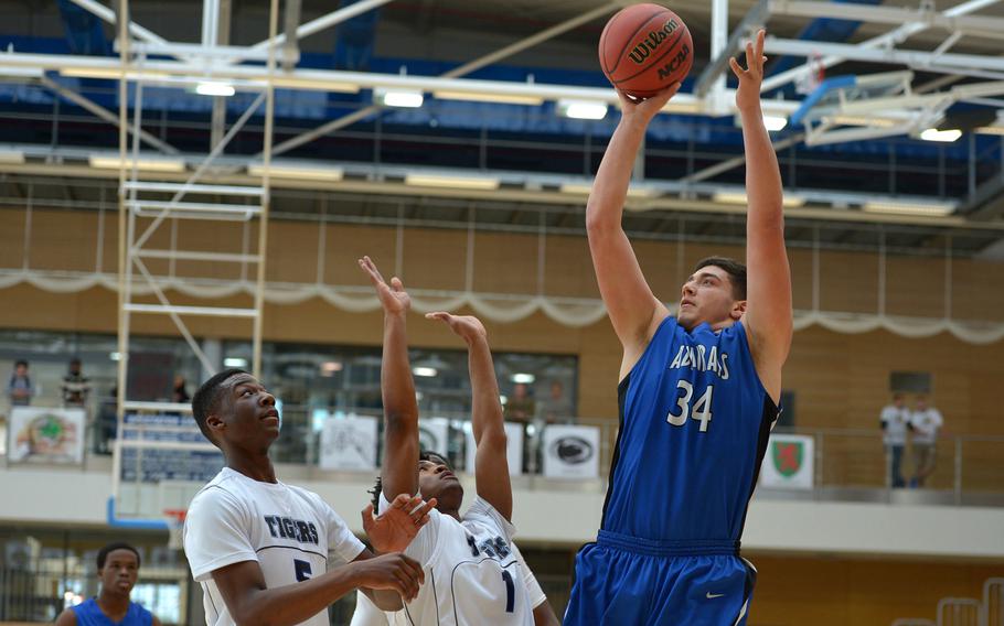 Rota's Andrew Drake shoots over Keyshawn Hunter, left, and Marshall Eddie in a Division II semifinal at the DODDS-Europe basketball championships in WIesbaden, Germany. Friday, Feb. 26, 2016. Rota defeated Hohenfels 54-36 to advance to Saturday's final against Black Forest Academy.

