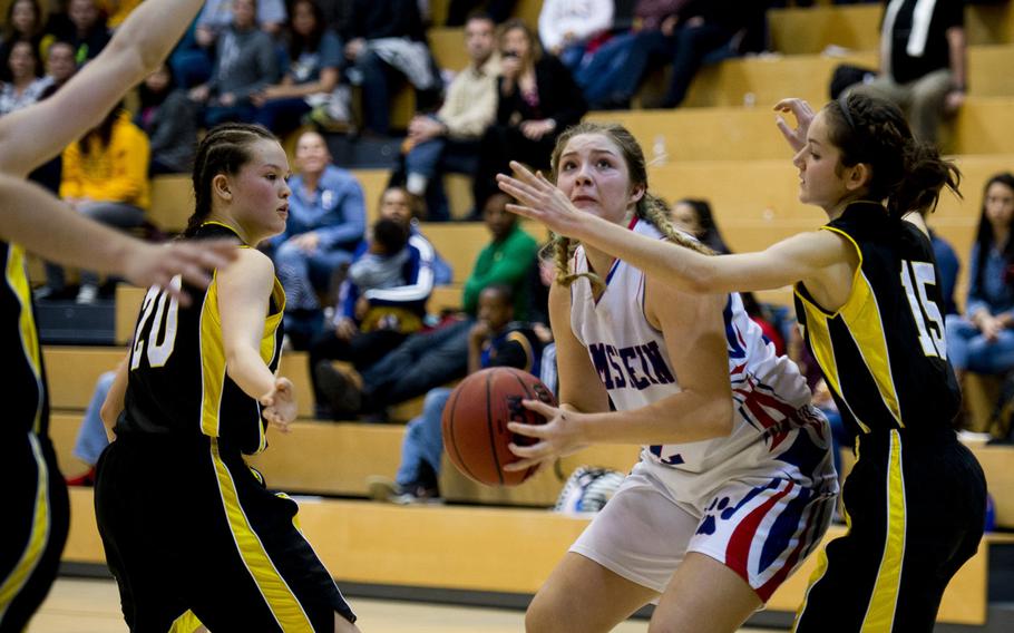 Ramstein's Lindsey Breton prepares to shoot over Stuttgart's Morgan Whitten, right, and Meaghan Ambelang during a DODDS-Europe Division I semifinal game at Clay Kaserne, Germany, Friday, Feb. 26, 2016. Ramstein won the game 31-30. 