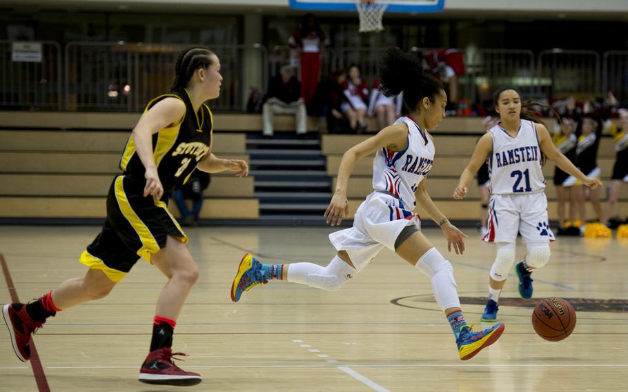 Ramstein's Desiree Palacios dribbles past Stuttgart's Meaghan Ambelang during a DODDS-Europe Division I semifinal game at Clay Kaserne, Germany, Friday, Feb. 26, 2016. Ramstein won the game 31-30. 