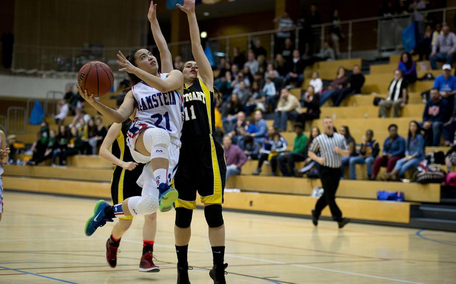 Ramstein's Ashley Mateo shoots past Stuttgart's Kat Farrar during a DODDS-Europe Division I semifinal game at Clay Kaserne, Germany, Friday, Feb. 26, 2016. Ramstein won the game 31-30. 