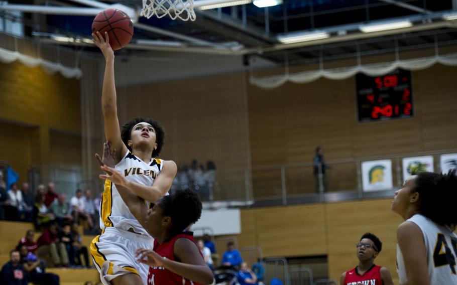 Vicenza's Jordan Wakefield goes for a layup over Kaiserslautern's Breanna Jones during a DODDS-Europe Division I semifinal game at Clay Kaserne, Germany, Friday, Feb. 26, 2016. Vicenza beat Kaiserslautern 46-29. 
