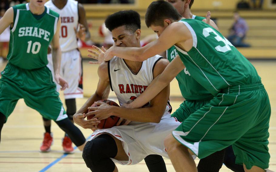 Kaiserslautern's Markell Johnson feels the pressure of SHAPE's Zackery Reed as they fight for the ball in  a Division I semifinal at the DODDS-Europe basketball championships in WIesbaden, Germany. Friday, Feb. 26, 2016. Kaiserslautern beat SHAPE 42-27 to advance to Saturday's final against Ramstein.