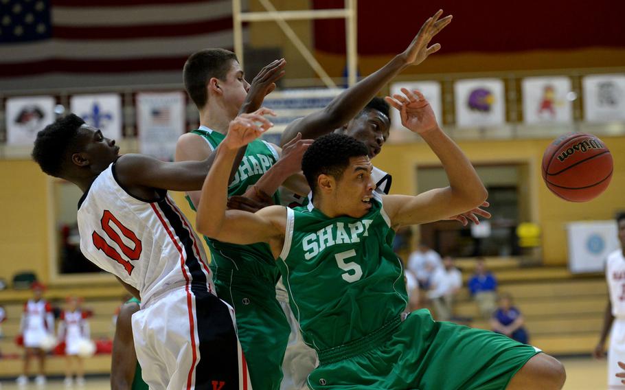 A group of SHAPE and Kaiseslautern players watch a loose ball bounce away in first-half action of a Division I semifinal at the DODDS-Europe basketball championships in WIesbaden, Germany. Friday, Feb. 26, 2016. Kaiserslautern beat SHAPE 42-27 to advance to Saturday's final against Ramstein.