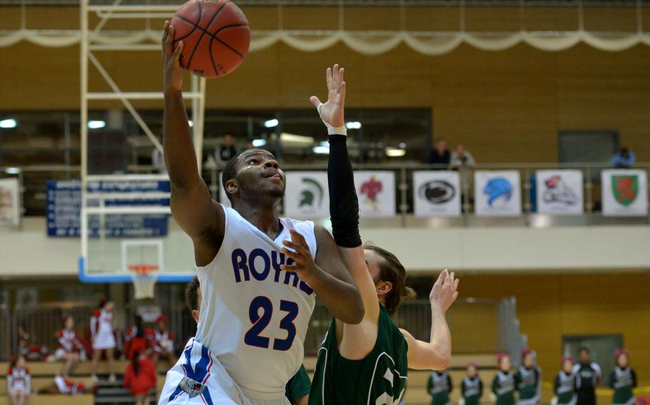 Ramstein's T.J. Williams goes to the hoop against Naples' Matt Bruhn  in a Division I semifinal at the DODDS-Europe basketball championships in WIesbaden, Germany. Friday, Feb. 26, 2016. Ramstein won 60-41 to advance to Saturday's final against Kaiserslautern.