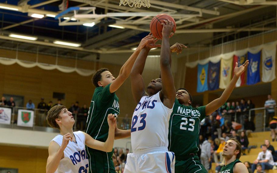 Naples Naples' Karrington Evans, left, and Tyrone Haynes fight Ramstein's T.J. Williams for a rebound  in a Division I semifinal at the DODDS-Europe basketball championships in WIesbaden, Germany. Friday, Feb. 26, 2016. Ramstein won 60-41 to advance to Saturday's final against Kaiserslautern. 