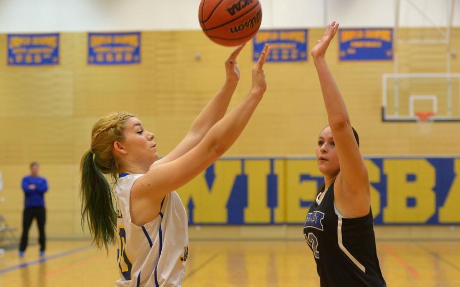 Sigonella's Lynda Reed takes a shot over Incirlik's Chris Carpenter-Lopez in a Division III game at the DODDS-Europe basketball championships in Wiesbaden, Germany, Friday, Feb. 26, 2016. Sigonella won the game 35-9.
