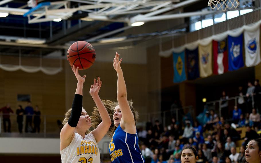 Ansbach's Liena Tatum takes a shot over Sigonella's Jessica Jacobs during the DODDS-Europe Division III championship game in Wiesbaden, Germany, Saturday, Feb. 27, 2016. Ansbach beat Sigonella in double overtime 34-30 to win the title. 