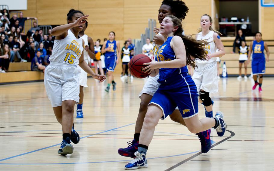 Sigonella's Jessica Jacobs gets past Ansbach's Katelynn Patterson, left, and Tytianna Martinez during the DODDS-Europe Division III championship game in Wiesbaden, Germany, Saturday, Feb. 27, 2016. Sigonella lost 34-30 in double overtime. 