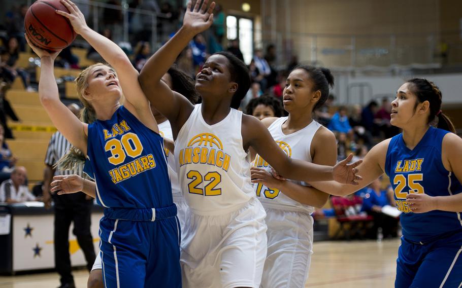 Sigonella's Lynda Reed tries to get a layup past Sabian Edouard during the DODDS-Europe Division III championship game in Wiesbaden, Germany, Saturday, Feb. 27, 2016. Sigonella lost 34-30 in double overtime. 