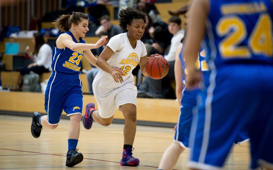 Ansbach's Tytianna Martinez dribbles past Sigonella's Daria Baker during the DODDS-Europe Division III championship game in Wiesbaden, Germany, Saturday, Feb. 27, 2016. Ansbach beat Sigonella in double overtime 34-30 to win the title. 