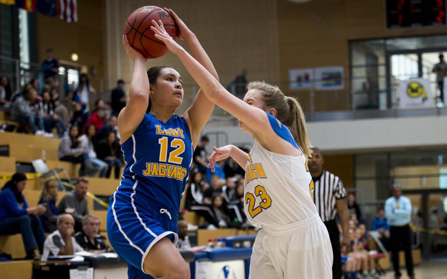Sigonella's Marika Wojtal shoots over Ansbach's Liena Tatum during the DODDS-Europe Division III championship game in Wiesbaden, Germany, Saturday, Feb. 27, 2016. Sigonella lost the game 34-30 in double overtime.