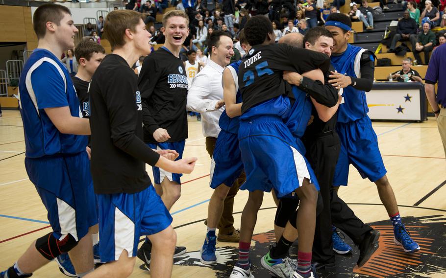 The Brussels Brigands celebrate after winning the DODDS-Europe Division III championship game in Wiesbaden, Germany, Saturday, Feb. 27, 2016. Brussels defeated the Ansbach Cougars 41-38.