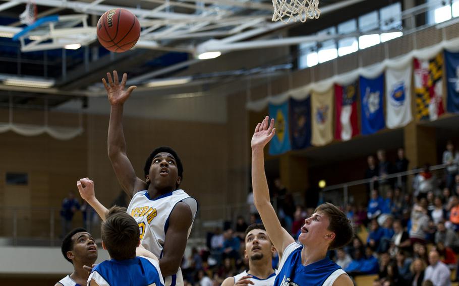Ansbach's Ogden Andrew shoots over the Brussels defense during the DODDS-Europe Division III championship game in Wiesbaden, Germany, Saturday, Feb. 27, 2016. Ansbach lost 41-38.