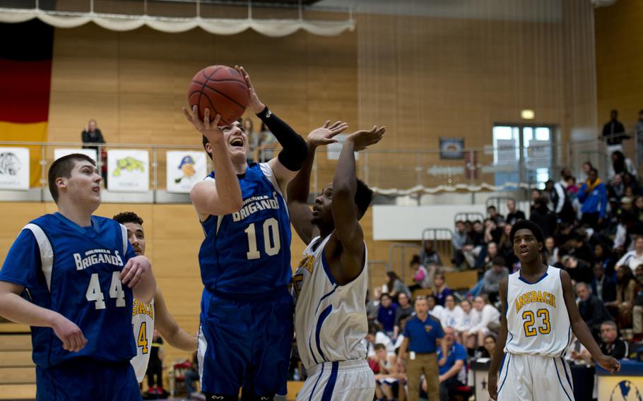 Brussels' Dominick DeFazio goes for a shot over Ansbach's Sam Sasser during the DODDS-Europe Division III championship game in Wiesbaden, Germany, Saturday, Feb. 27, 2016. Brussels won the game 41-38 to win the title. 
