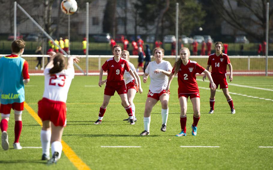 Lakenheath's Kathryn Mayssonet, left, throws the ball in to teammates in Kaiserslautern, Germany, on Saturday, March 26, 2016. Lakenheath lost the game 6-1.