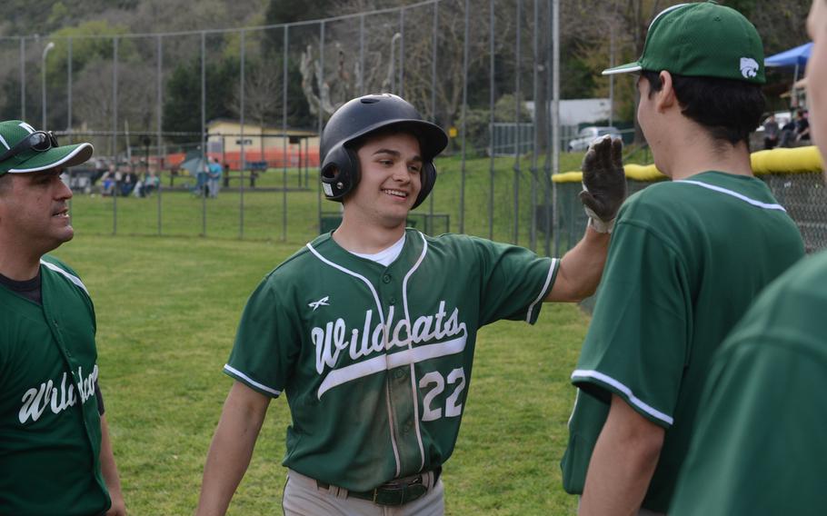 Naples senior Robert Dromerhauser is greeted after his three-run home run put the Wildcats up in their Friday, April 1, 2016, game against the Vicenza Cougars in Naples. The Wildcats would go on to win, 6-3, their second win of opening-day play. 