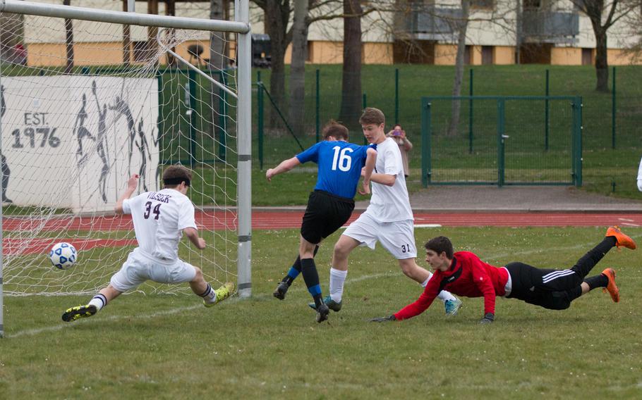 Hohenfels' Jacob Nantz threads a goal past three Vilseck defenders during the Tigers' 3-2 loss to the Falcons during a game in Vilseck, Germany, Thursday, April 7, 2016. 