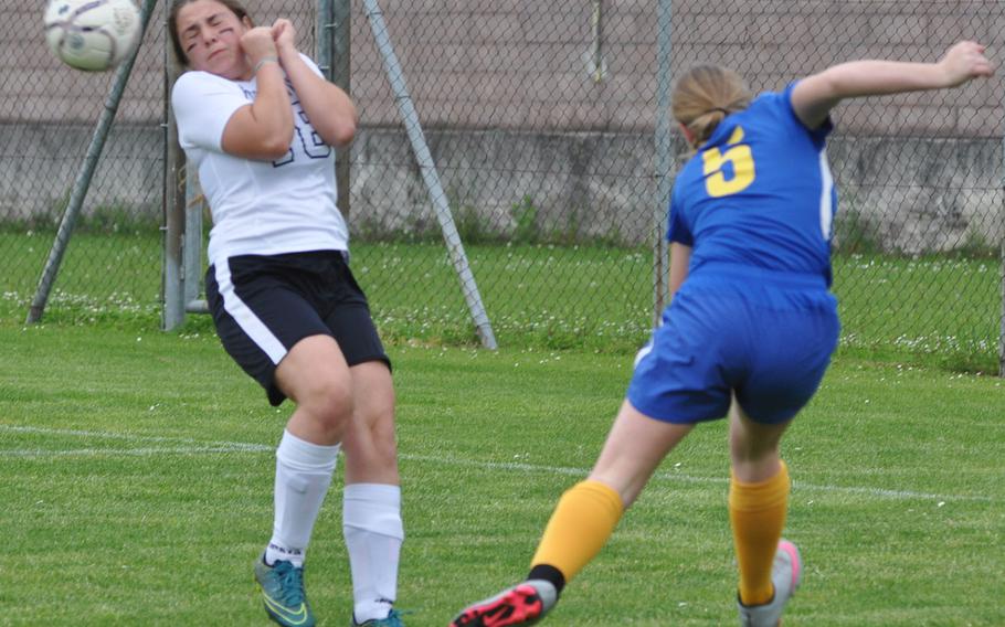 Aviano's Megan Slabaugh manages to avoid getting hit by a kick from Sigonella's Violender Doke in the Jaguars' 4-1 victory over the Saints on Friday.